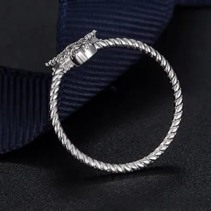 Macro side view of S925 silver rope band ring with shimmering pavé diamond accents