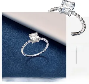 Close-up of square cut zircon ring with beaded band and four-prong silver setting