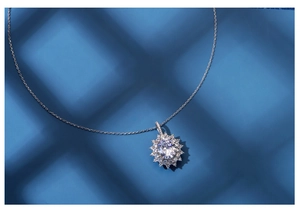 Detailed close-up of a sunflower necklace with oval main stone and halo diamonds