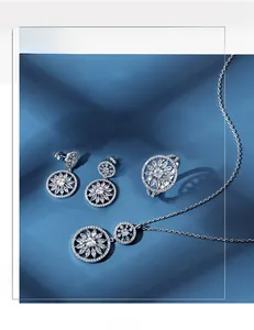 Macro detail of S925 sterling silver snowflake jewelry set on blue textured fabric