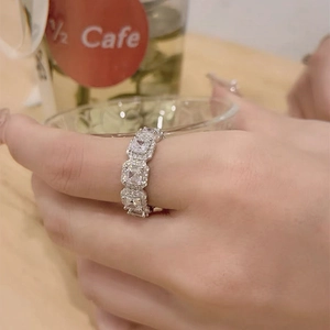 Close-up of S925 silver ring with square zircon halo stones worn on a model's finger