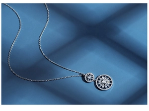 Detailed view of S925 silver sunflower pendant with marquise-cut crystals on blue background