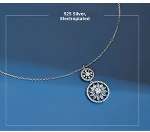 Close-up of S925 silver necklace featuring nested rings with cubic zirconia flower inlay