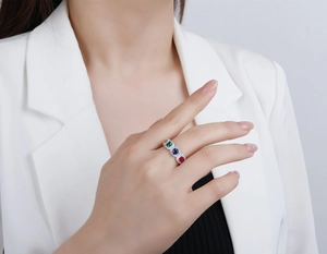 Detail of s925 silver ring featuring three colorful square zircons on female hand