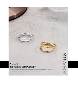 Macro detail of intertwined 925 sterling silver rings in gold and silver finishes