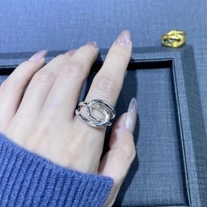 Polished 925 sterling silver intertwined ring shown on a model's finger for an elegant look