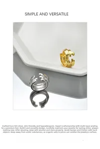 Close-up of gold and silver S925 sterling silver layered rings on a white tray