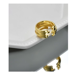 Close-up of golden multi-layer open ring with geometric grooves and polished finish