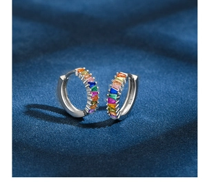Macro shot of S925 sterling silver huggie earrings with colorful baguette stones