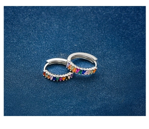 Macro shot of S925 silver hoop earrings featuring channel-set rainbow gradient zircons