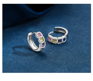 Detail of 925 sterling silver stamp and colorful rectangle-cut zircon stones on earrings
