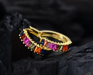 Detailed close-up of 925 silver gold-plated hoop earrings with colorful baguette-cut stones