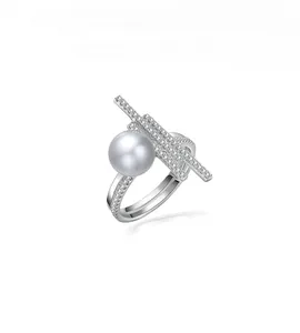 Macro shot of 925 silver geometric ring with large pearl and sparkling diamond accents