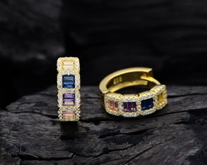 Macro view of gold-plated rainbow gemstone earrings with sparkling pave-set zircons