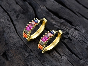 Detailed macro view of S925 sterling silver huggie earrings with colorful baguette stones