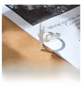 Macro detail of 925 sterling silver ring featuring a large pearl and paved geometric bars