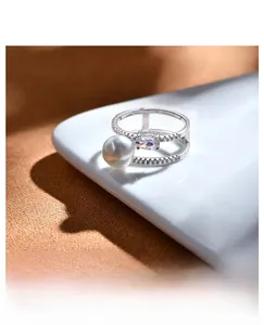 Detail of a 925 silver double-layer ring with pearl and zirconia in platinum finish