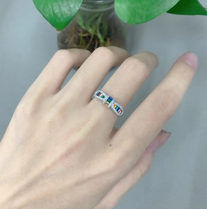 Macro view of a S925 silver bow ring featuring vibrant rainbow-colored zircon stones