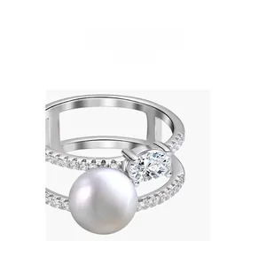 Macro shot of double-layer silver ring featuring a large white pearl and oval zircon stone