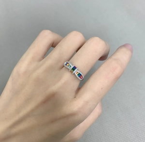 Detailed view of wave-shaped S925 silver ring with colorful rainbow zircons on hand