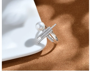 Macro shot of 925 silver pearl ring featuring triple rows of micro-pave cubic zirconia