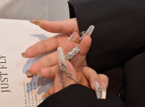 Detailed view of silver ring with full pave zircon stones and dangling butterfly charm