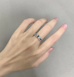 Macro shot of S925 silver ring featuring rainbow zircons in a bow-tie arrangement