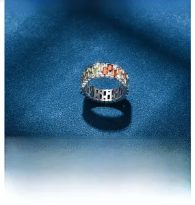 Macro view of multi-color rectangle cut gemstones and round diamonds on silver ring