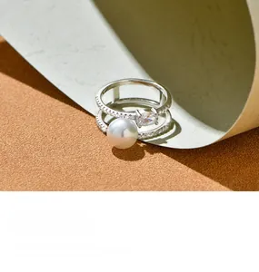 Detail of 925 silver double layer ring with glossy pearl and pavé-set crystals