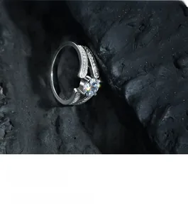Macro shot of S925 silver ring featuring a round zircon and pave-set split shank detail