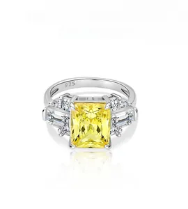 Macro detail of 925 silver ring featuring radiant cut yellow stone and trapezoid accents
