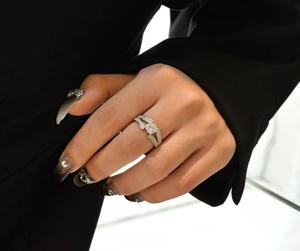 Macro detail of S925 sterling silver V-shape ring with sparkling zircon stones on finger