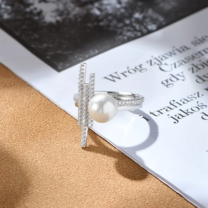 925 silver geometric ring with large pearl and vertical diamond-set rods on a beige surface