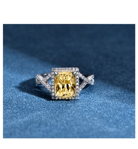 Macro shot of s925 silver ring featuring a radiant cut yellow gemstone with halo setting