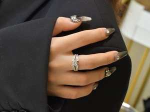 Close-up of S925 silver V-shaped ring with large round zircon on female hand