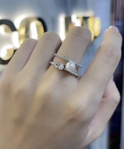 Detailed view of 925 sterling silver double-layer ring with pearl and oval stone