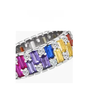 Macro shot of silver ring featuring multi-color baguette gemstones and small white diamonds