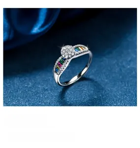 Macro detail of colorful baguette-cut zircons and center round diamond on silver ring