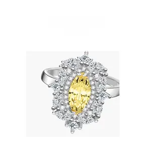 Macro view of sterling silver ring featuring yellow marquise cut gem and halo stones