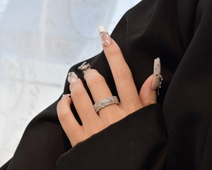 Detail of a 925 sterling silver luxury ring with pavé diamonds on a model hand
