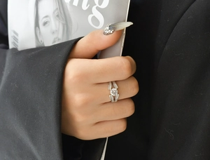 Close-up of S925 silver V-shaped ring with round zircon and pavé split shank on hand