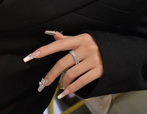 Détail d'une bague en argent 925 avec des zircons rectangulaires et ronds sur le doigt