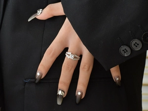 Detail of S925 sterling silver V-side ring with large round zircon on black blazer background