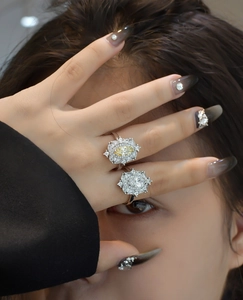 Detail of two vintage S925 silver rings with yellow marquise cut stones on a model's hand