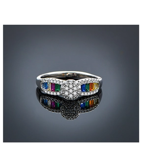 Detailed macro shot of silver ring with rainbow colored gemstones and center zircon stones