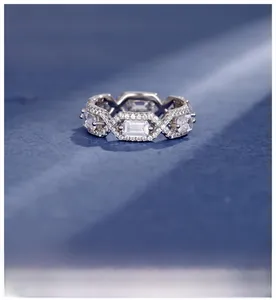 Macro shot of silver plated ring with emerald-cut crystals and geometric pavé settings