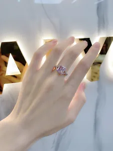 Close-up of s925 silver ring featuring a rectangle pink gemstone with halo diamonds