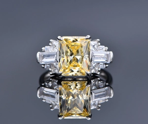 Macro shot of 925 silver ring featuring a yellow ice-cut gemstone and side stones