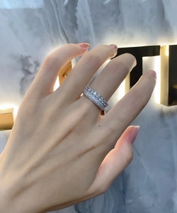 Close-up of double row micro-pave 925 silver rings with clear zircon stones on hand