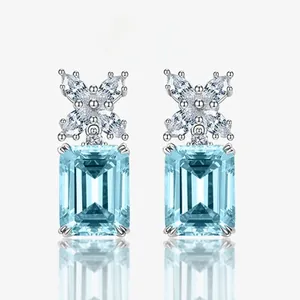 Detailed macro view of light blue rectangular gemstone earrings with silver marquise accents